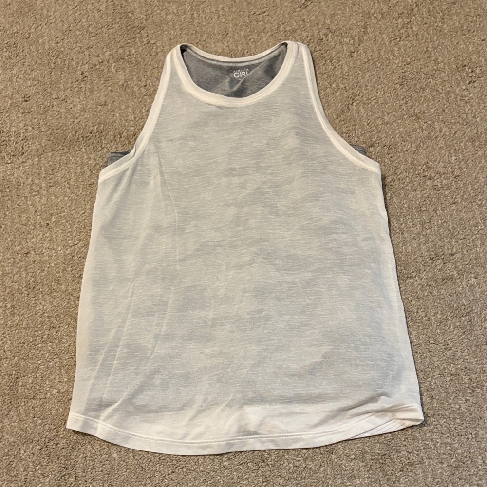 Athletic girl white tank top with gray camo second layer tank top underneath